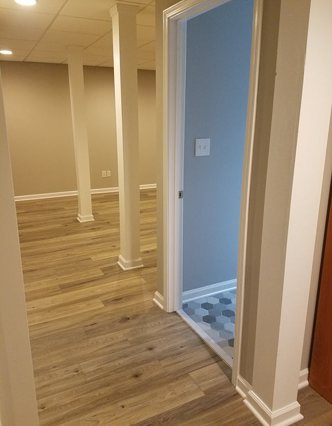 Basement remodel with LVT and peak into new bathroom